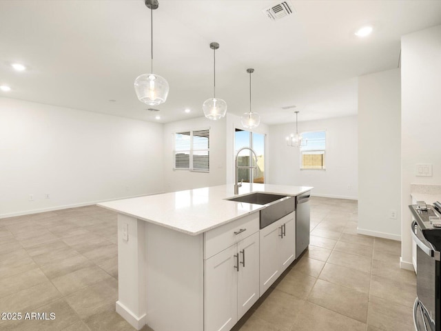 kitchen with white cabinetry, sink, an island with sink, pendant lighting, and appliances with stainless steel finishes