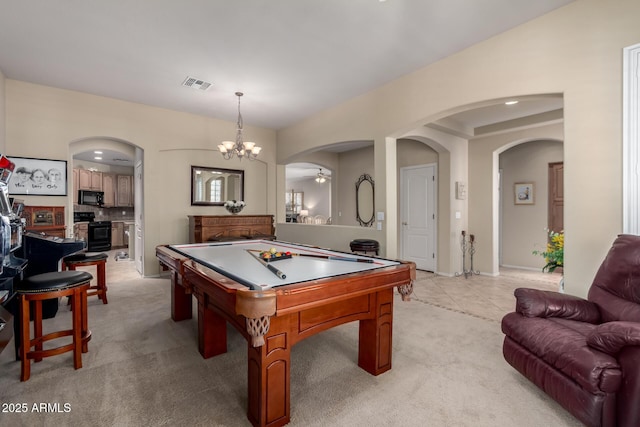 recreation room with visible vents, billiards, ceiling fan with notable chandelier, arched walkways, and light colored carpet