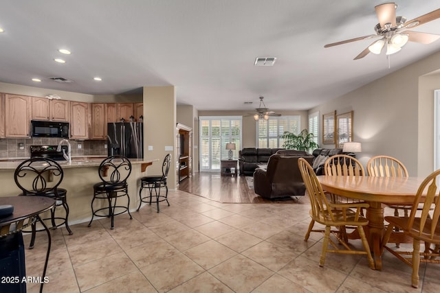 dining space with light tile patterned floors, visible vents, ceiling fan, and recessed lighting