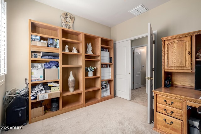 office area featuring visible vents and light colored carpet