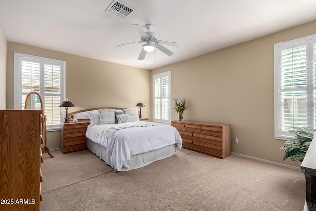 bedroom featuring visible vents, multiple windows, and carpet