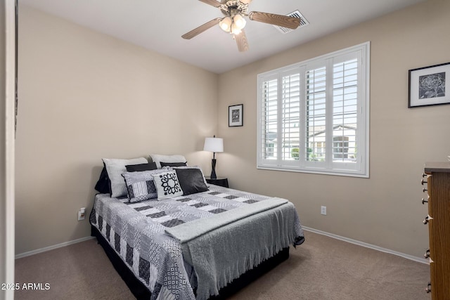 bedroom with ceiling fan, baseboards, and carpet