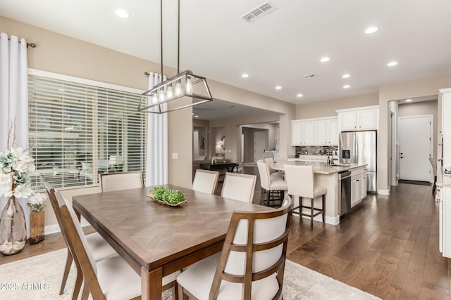 dining space with sink and dark hardwood / wood-style floors