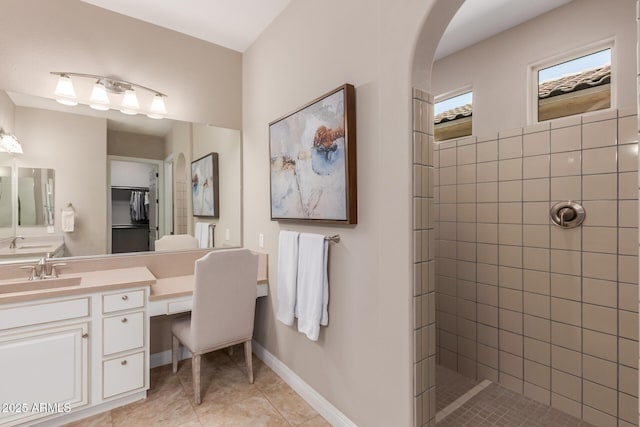 bathroom with vanity, tile patterned floors, and tiled shower