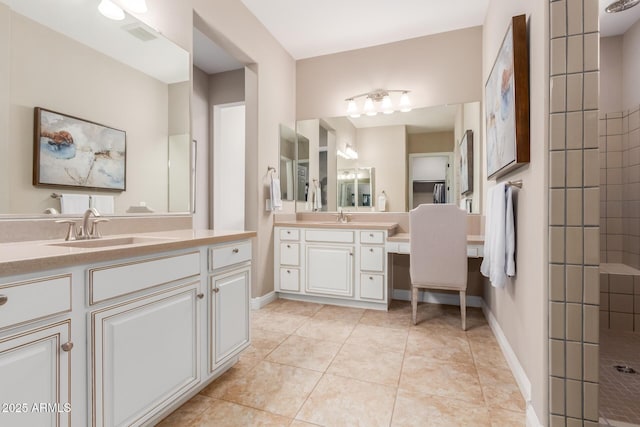 bathroom with tiled shower, tile patterned floors, and vanity