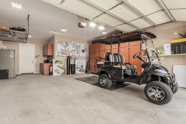 garage featuring a garage door opener and stainless steel fridge