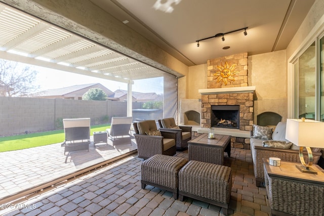 view of patio / terrace with a pergola and an outdoor living space with a fireplace