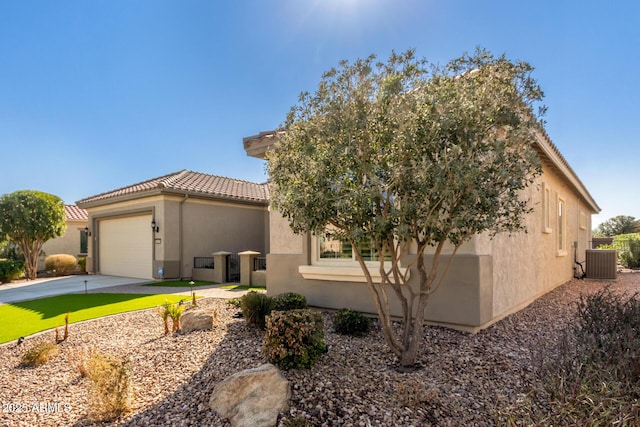 view of front of property featuring cooling unit and a garage