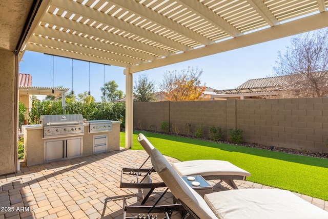 view of patio featuring area for grilling, a pergola, and exterior kitchen