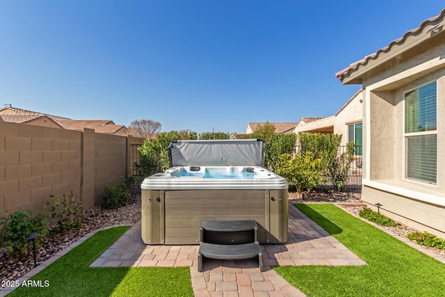 view of patio / terrace with a hot tub