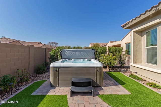 view of yard with a hot tub and a patio