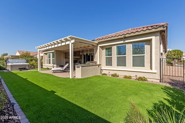 rear view of property featuring a lawn, an outdoor kitchen, a pergola, a hot tub, and a patio area