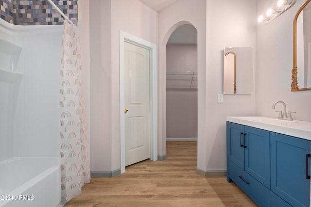 bathroom with hardwood / wood-style floors, shower / bath combo, and oversized vanity