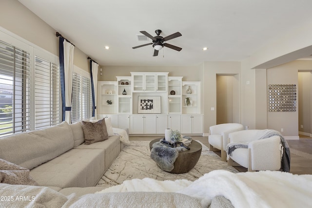 living room featuring ceiling fan and a wealth of natural light