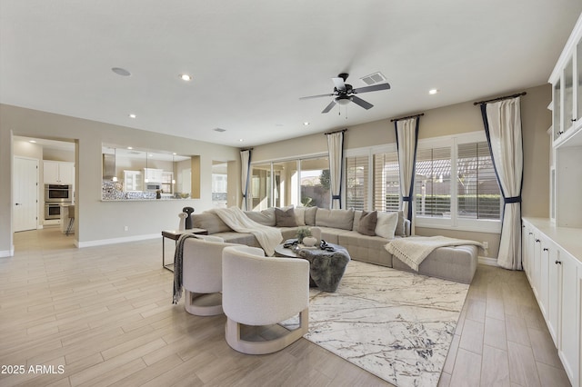 living room with ceiling fan and light hardwood / wood-style floors