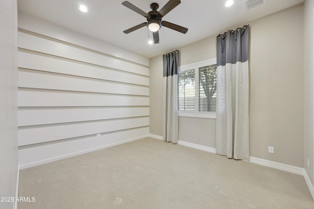 spare room with light colored carpet and ceiling fan