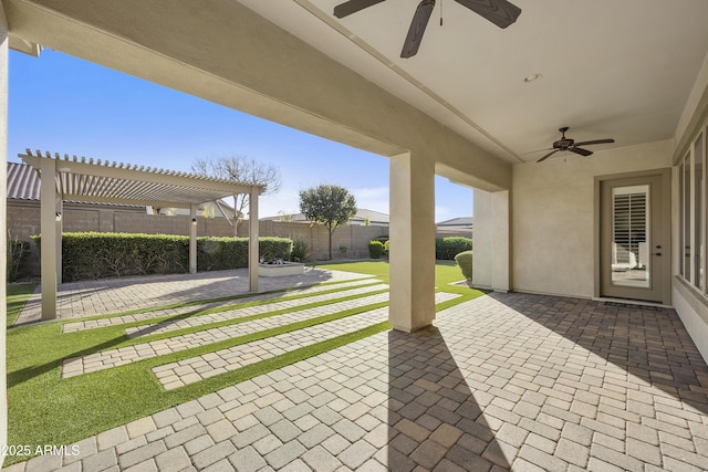 view of patio / terrace with ceiling fan and a pergola