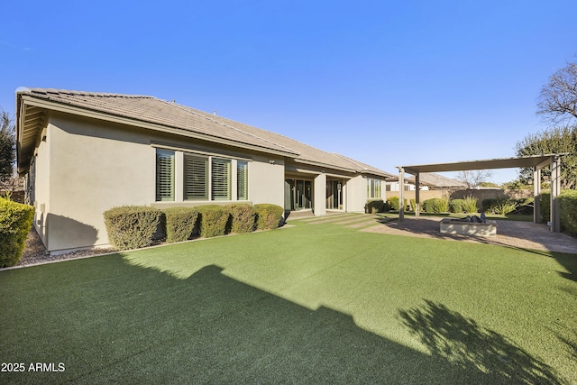 back of property featuring a patio area and a lawn