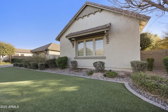 view of property exterior with a yard