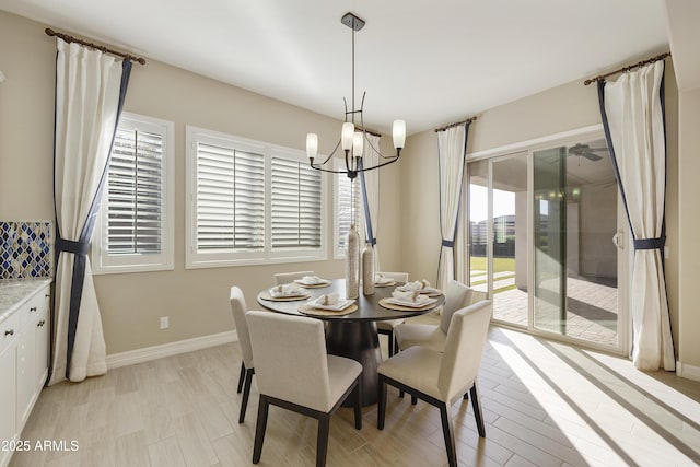 dining area featuring a notable chandelier and light wood-type flooring