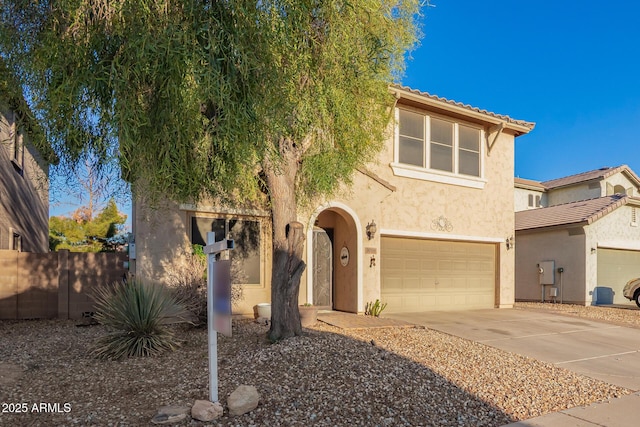 9009 S 57th Dr, Laveen, AZ 85339 - view of front of house featuring a tile roof, concrete driveway, stucco siding, fence, and a garage