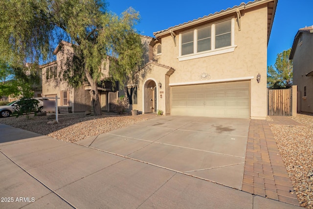 9009 S 57th Dr, Laveen, AZ 85339 - view of front of house with a tiled roof, concrete driveway, stucco siding, and an attached garage