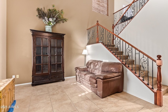 9009 S 57th Dr, Laveen, AZ 85339 - stairway with a high ceiling, tile patterned floors, and baseboards