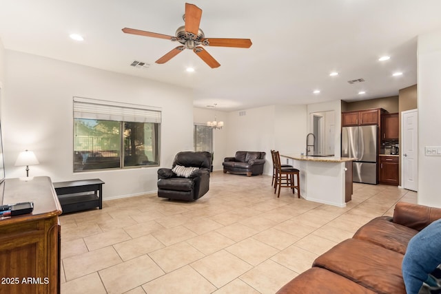 9009 S 57th Dr, Laveen, AZ 85339 - living area with light tile patterned floors, recessed lighting, ceiling fan with notable chandelier, and visible vents
