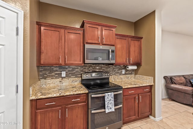 9009 S 57th Dr, Laveen, AZ 85339 - kitchen with light stone countertops, tasteful backsplash, light tile patterned floors, and appliances with stainless steel finishes