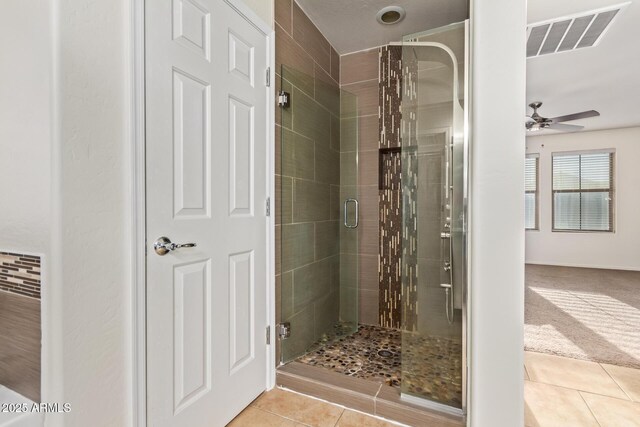 9009 S 57th Dr, Laveen, AZ 85339 - full bath featuring tile patterned floors, a shower stall, ceiling fan, and visible vents