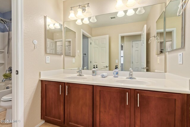 9009 S 57th Dr, Laveen, AZ 85339 - bathroom featuring double vanity, a sink, toilet, and visible vents