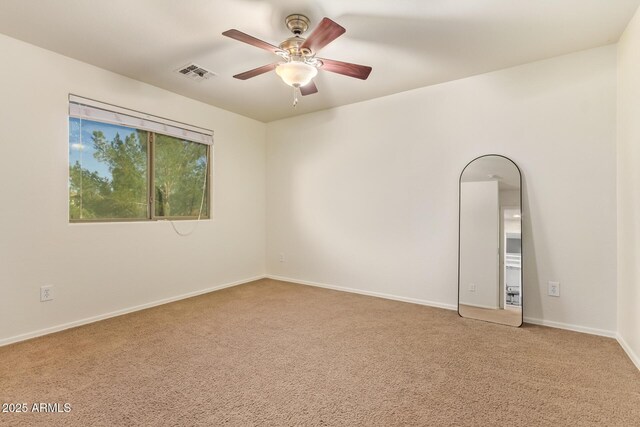 9009 S 57th Dr, Laveen, AZ 85339 - carpeted spare room with baseboards, visible vents, and a ceiling fan