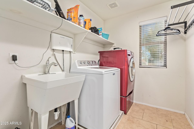 9009 S 57th Dr, Laveen, AZ 85339 - washroom featuring visible vents, baseboards, laundry area, washer and clothes dryer, and light tile patterned floors
