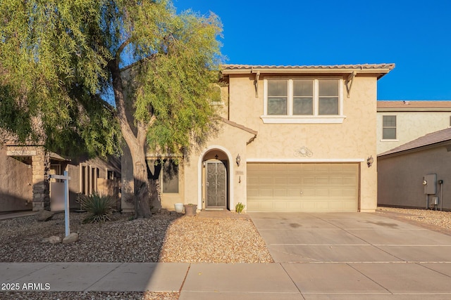 9009 S 57th Dr, Laveen, AZ 85339 - view of front of house featuring a tile roof, stucco siding, an attached garage, and concrete driveway