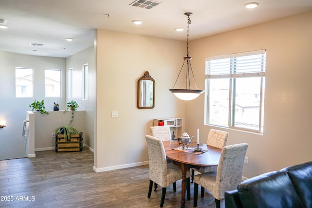 dining room with visible vents, baseboards, and wood finished floors