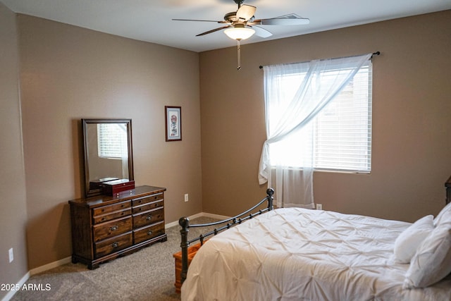 carpeted bedroom featuring baseboards and ceiling fan