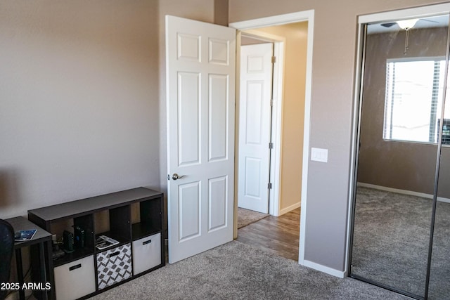 unfurnished bedroom featuring carpet and baseboards