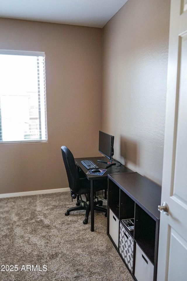 carpeted office featuring baseboards