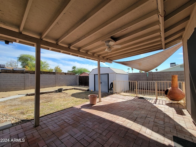 view of patio / terrace with a storage shed and ceiling fan