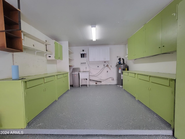 kitchen with sink, green cabinets, and gas water heater