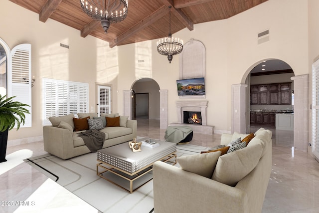 living room with beamed ceiling, high vaulted ceiling, wooden ceiling, and a chandelier