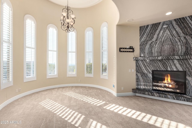 unfurnished living room featuring carpet floors and plenty of natural light