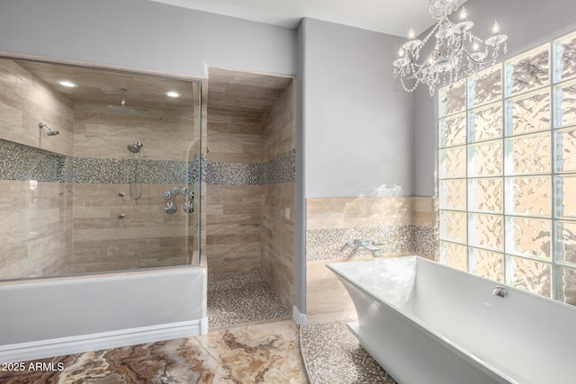 bathroom with a chandelier and separate shower and tub