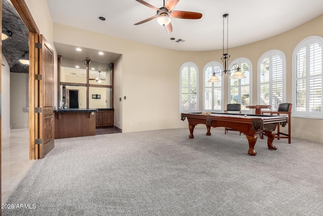 rec room with ceiling fan with notable chandelier and light colored carpet