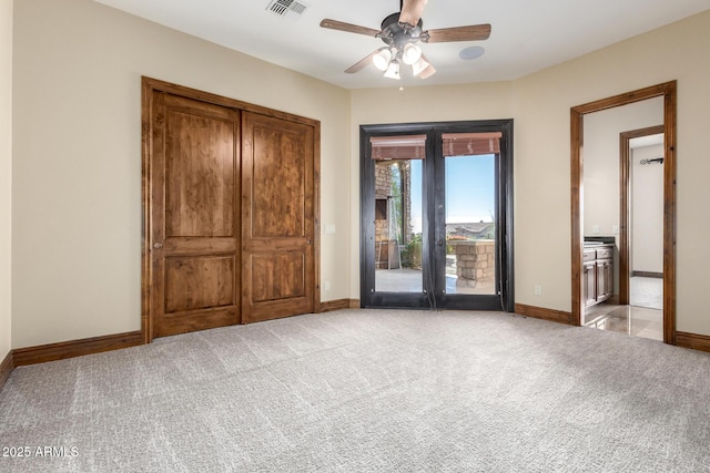 unfurnished bedroom featuring light carpet, access to outside, and ceiling fan