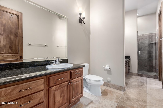 bathroom featuring vanity, a shower with shower door, and toilet