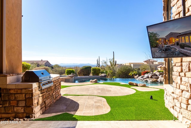 view of yard featuring a patio and exterior kitchen