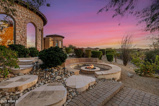 patio terrace at dusk with a fire pit