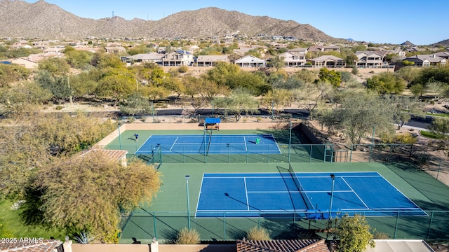 view of tennis court featuring a mountain view