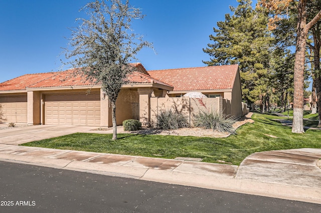 view of front of property featuring a garage and a front lawn